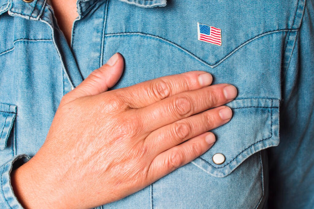 close up patriotic woman with hand heart