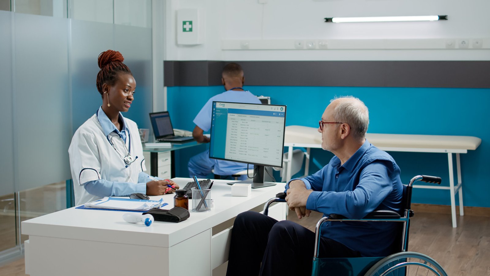 general practitioner doing checkup visit with patient in wheelchair